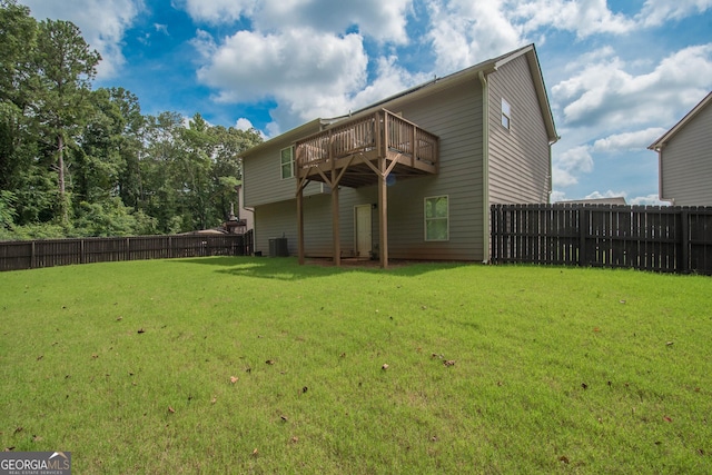 back of house with a wooden deck, a yard, and cooling unit