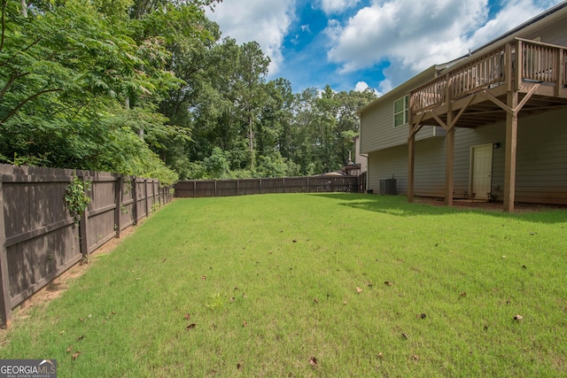 view of yard with a deck and cooling unit