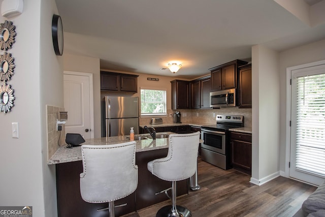 kitchen featuring plenty of natural light, sink, appliances with stainless steel finishes, and tasteful backsplash