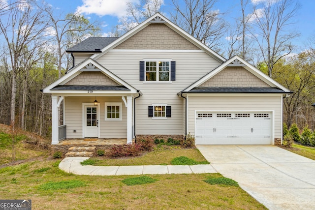 craftsman inspired home with covered porch, a garage, and a front lawn