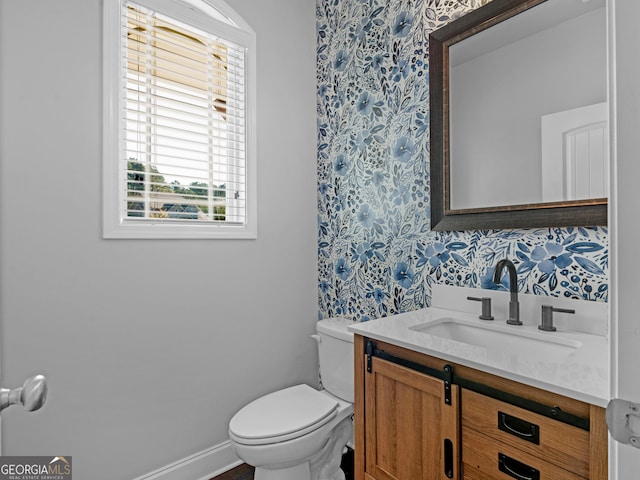 bathroom featuring vanity and toilet