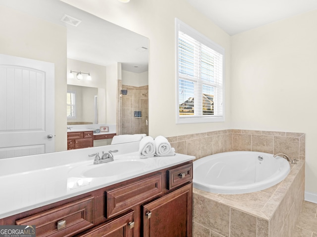 bathroom with vanity and separate shower and tub