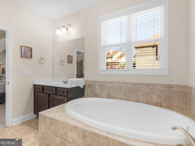 bathroom with tile patterned floors, vanity, and tiled tub