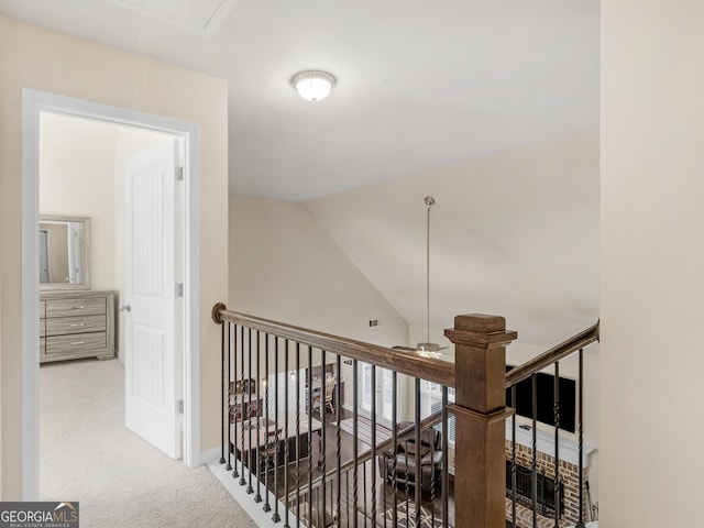 corridor featuring carpet and lofted ceiling