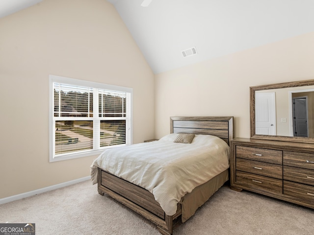 carpeted bedroom featuring high vaulted ceiling