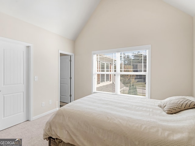 carpeted bedroom with vaulted ceiling