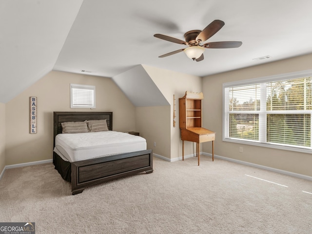 carpeted bedroom with ceiling fan and vaulted ceiling