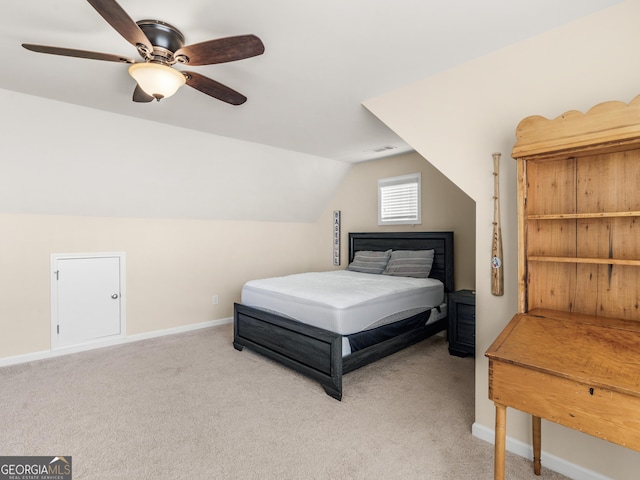 bedroom with ceiling fan, lofted ceiling, and light carpet