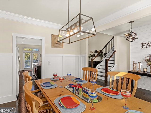 dining room with crown molding, dark wood-type flooring, and french doors