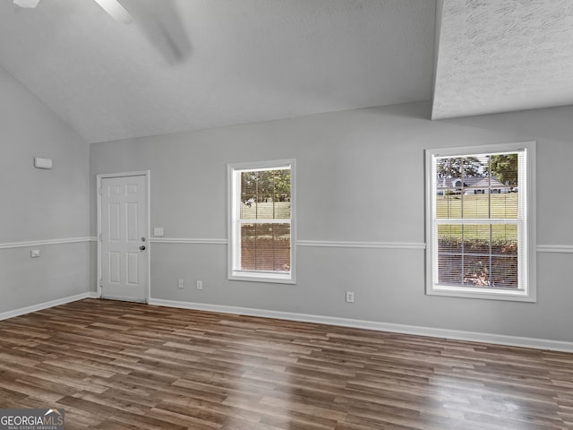 unfurnished room with dark hardwood / wood-style flooring, ceiling fan, and lofted ceiling