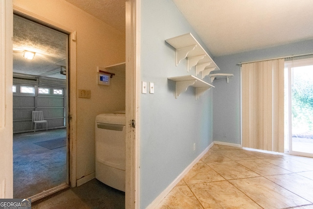 washroom featuring washer / dryer and a textured ceiling