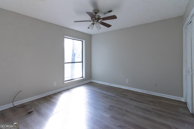 unfurnished bedroom with dark wood-type flooring and ceiling fan