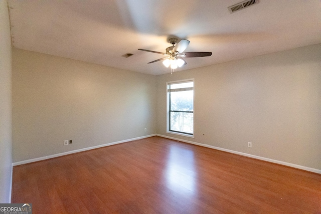 spare room featuring ceiling fan and wood-type flooring