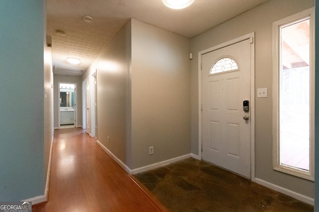 foyer entrance with dark hardwood / wood-style floors