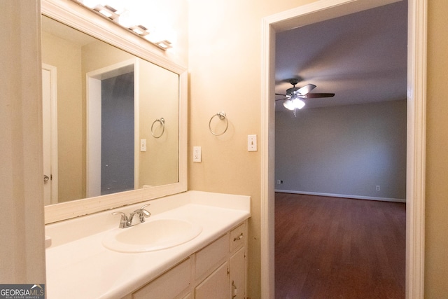 bathroom with hardwood / wood-style flooring, ceiling fan, and vanity