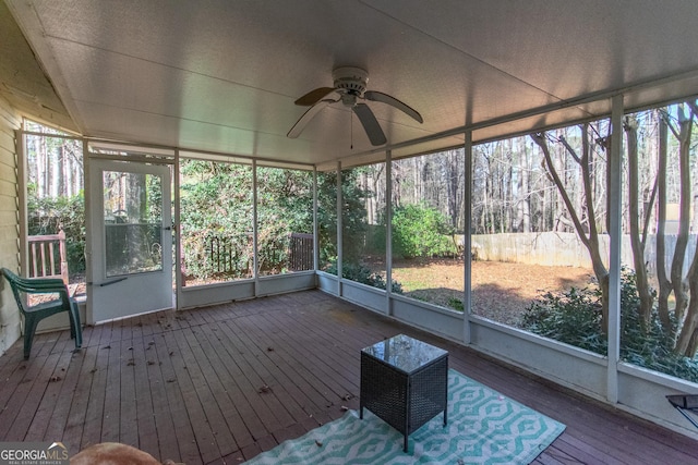 unfurnished sunroom with ceiling fan