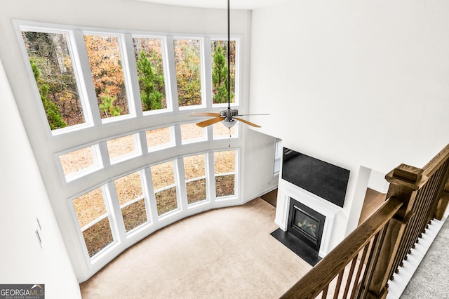 carpeted living room featuring ceiling fan