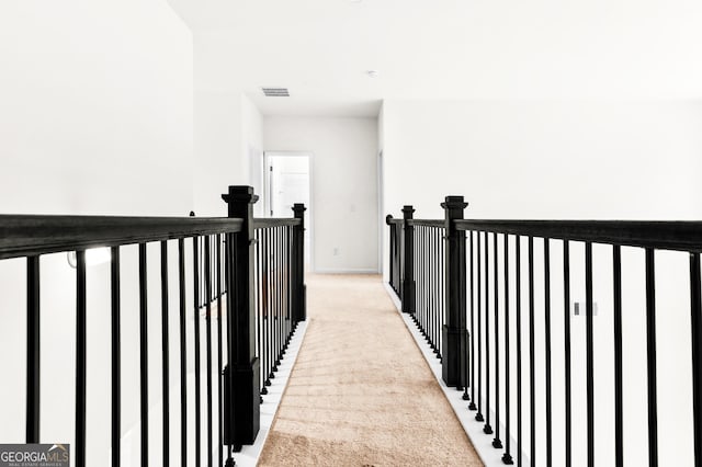 hall with light colored carpet