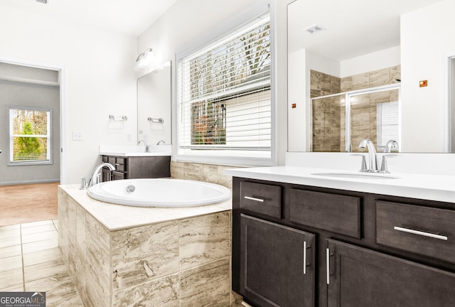 bathroom with tile patterned flooring, vanity, separate shower and tub, and plenty of natural light