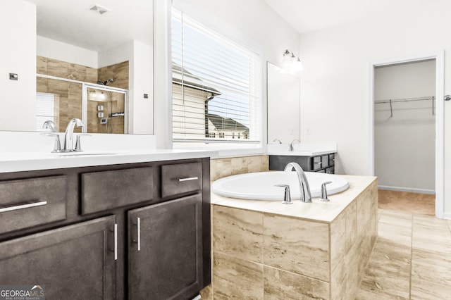 bathroom featuring separate shower and tub, tile patterned floors, and vanity