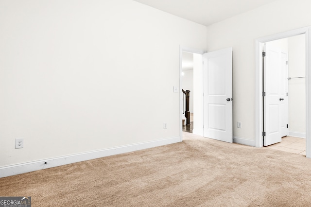 unfurnished bedroom with light colored carpet