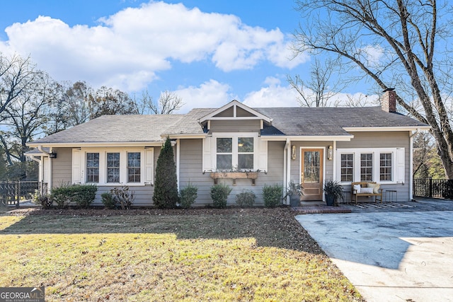 ranch-style home with a front yard