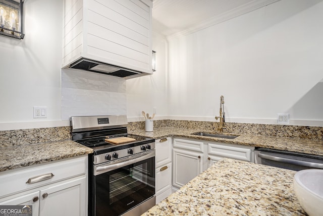 kitchen with sink, light stone counters, crown molding, white cabinets, and appliances with stainless steel finishes