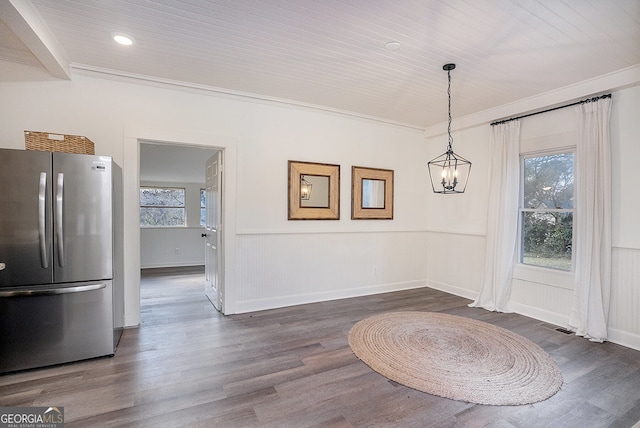 unfurnished dining area with dark wood-type flooring and ornamental molding