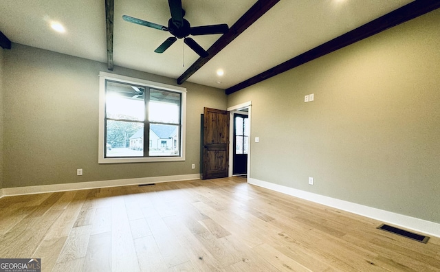 spare room with ceiling fan, beamed ceiling, and light hardwood / wood-style floors