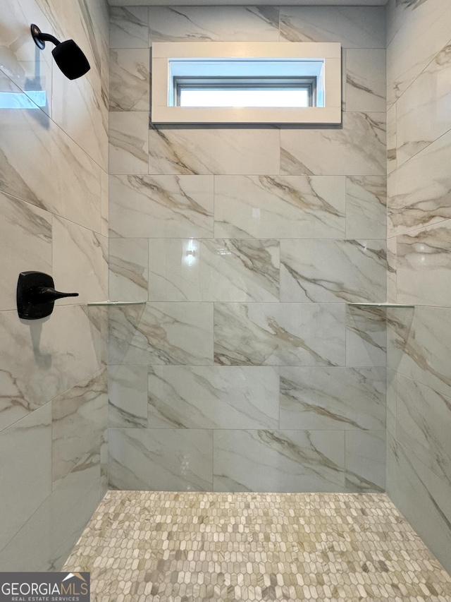 bathroom with a tile shower