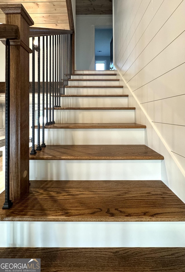 stairway with wood walls