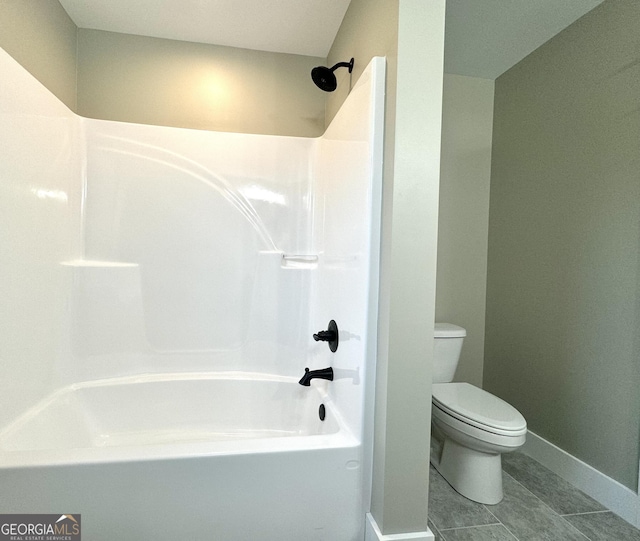 bathroom with tile patterned floors, shower / bathing tub combination, and toilet