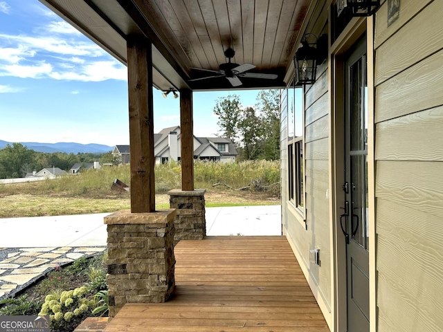 deck featuring a mountain view and ceiling fan