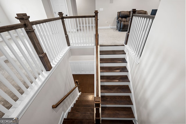 stairs featuring a high ceiling