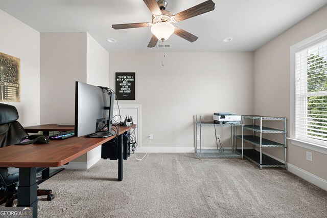 carpeted home office with ceiling fan