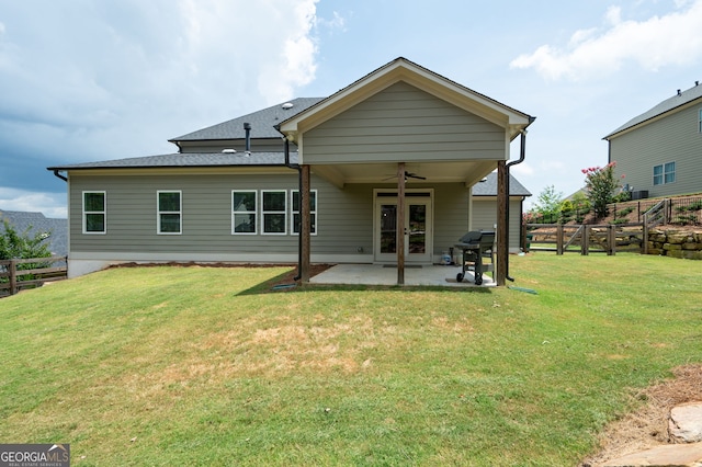 rear view of property featuring a yard, a patio, and ceiling fan