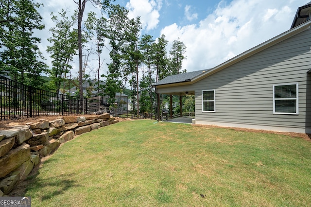 view of yard with ceiling fan and a patio