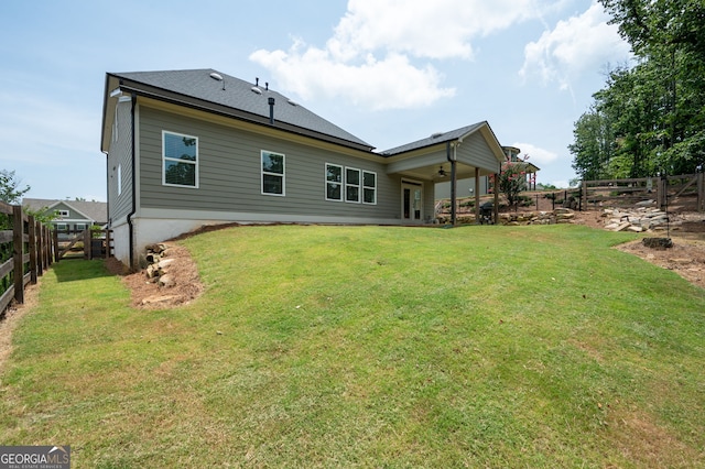 back of house with a yard and ceiling fan