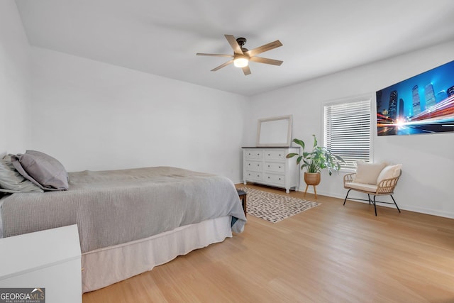 bedroom with ceiling fan and wood-type flooring