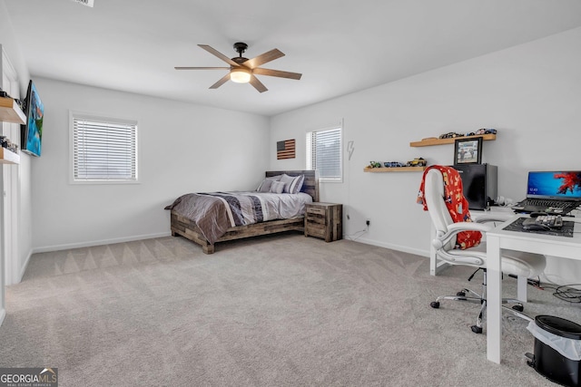 bedroom featuring multiple windows, ceiling fan, and light carpet