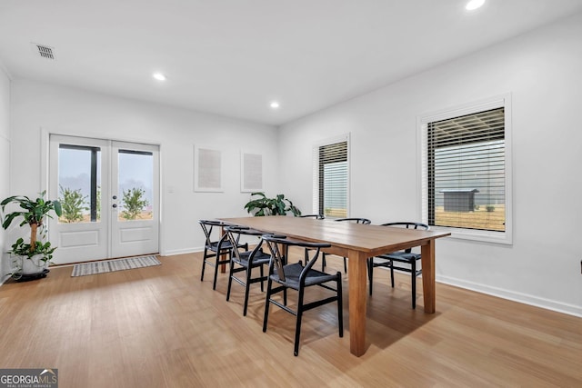 dining area featuring french doors and light wood-type flooring