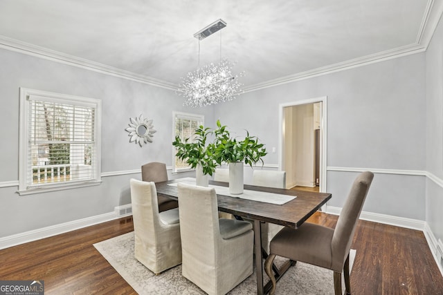 dining space with dark hardwood / wood-style floors, crown molding, and a notable chandelier