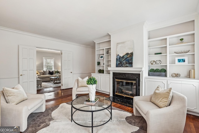 living room with crown molding, a high end fireplace, and dark wood-type flooring