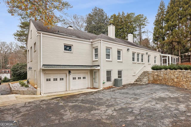 exterior space featuring a garage and central air condition unit