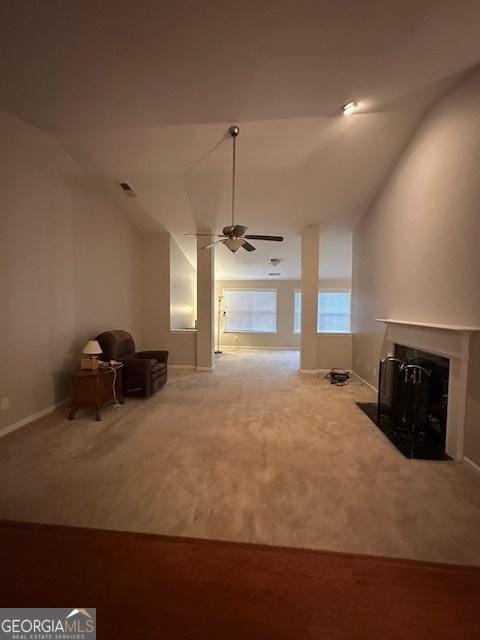 unfurnished living room with carpet flooring, lofted ceiling, a ceiling fan, and a fireplace