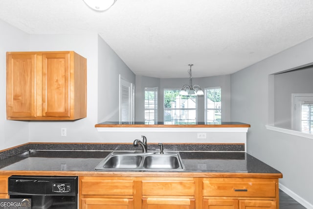 kitchen featuring dishwasher, sink, decorative light fixtures, a textured ceiling, and a notable chandelier