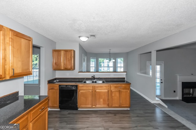 kitchen with sink, hanging light fixtures, dark hardwood / wood-style floors, black dishwasher, and a chandelier