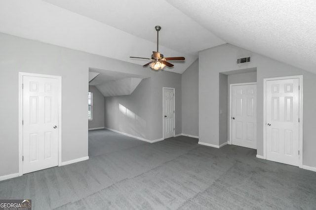 bonus room featuring ceiling fan, carpet floors, a textured ceiling, and vaulted ceiling