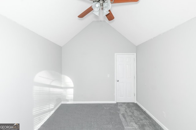 carpeted empty room featuring vaulted ceiling and ceiling fan