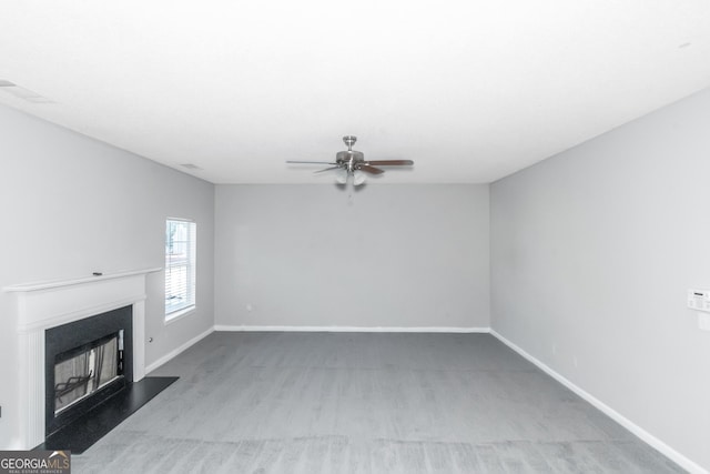 unfurnished living room with carpet flooring and ceiling fan